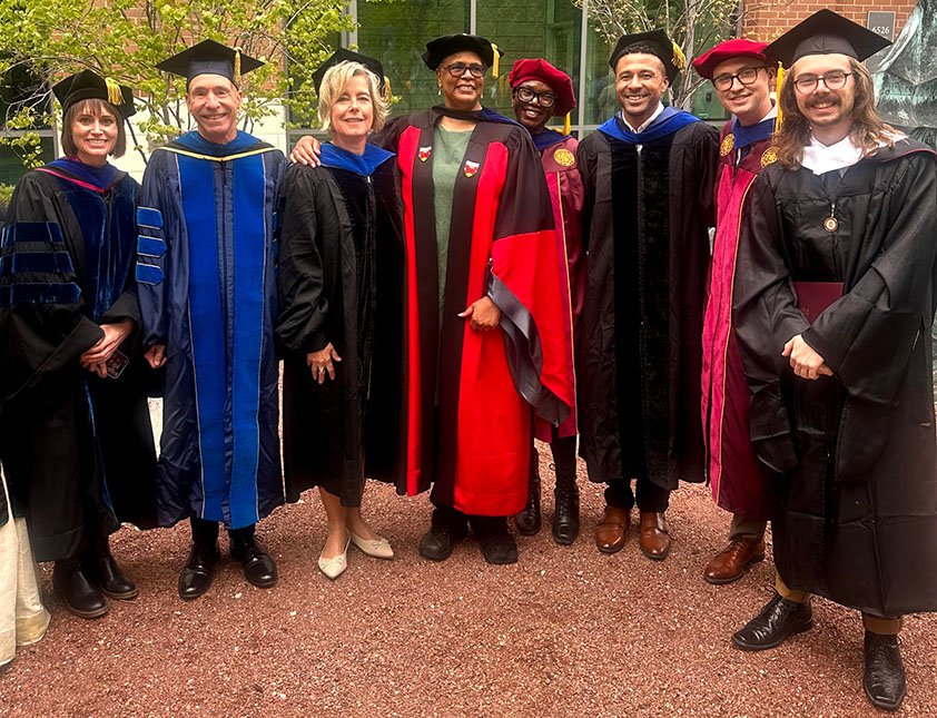 2026 Philosophy PhD graduates Dr. Andrew Krema and Dr. LaChanda Davis and MA graduate Mason Bowes celebrate with department faculty